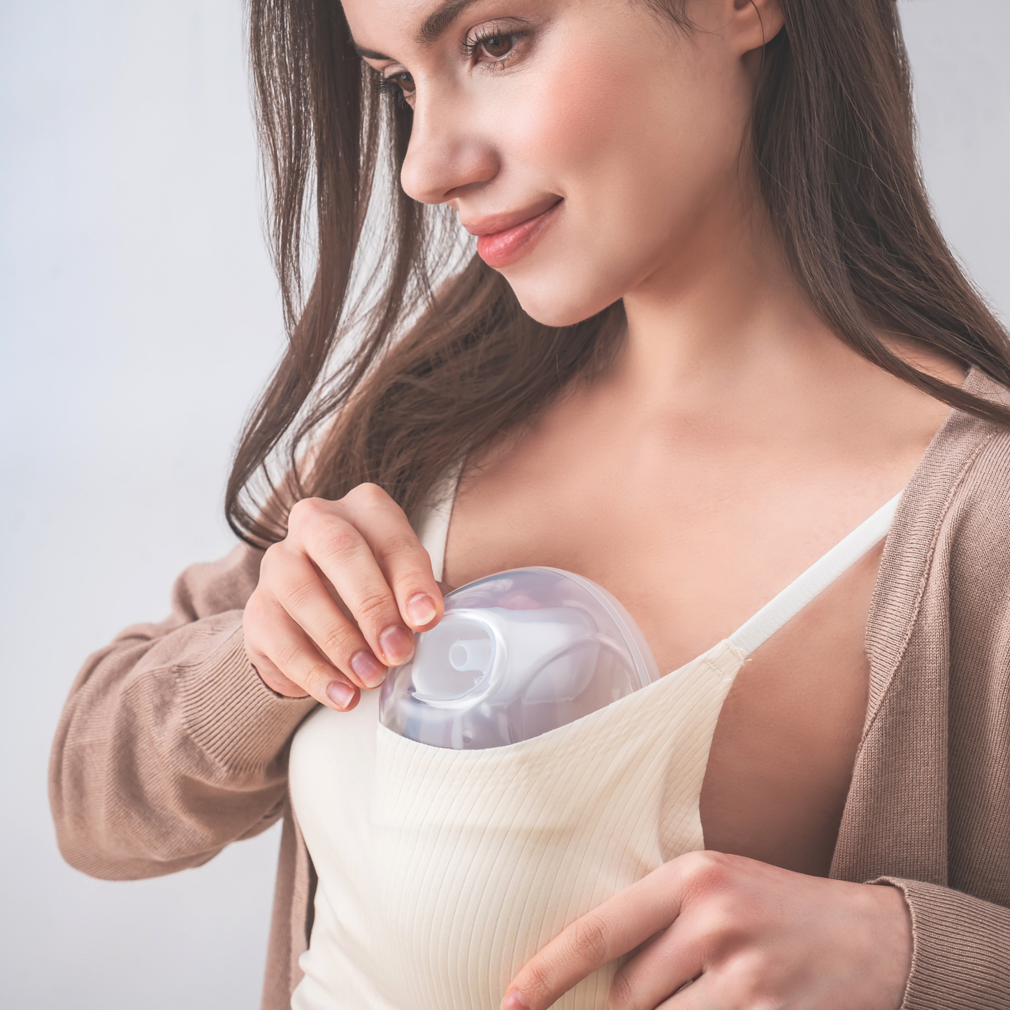 woman putting Cimilre hands free collection cups into bra