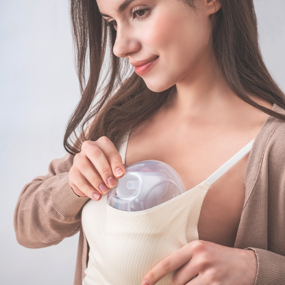 woman putting Cimilre hands free collection cups into bra