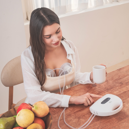 woman sitting with Cimilre hands free collection cups and S7 with fruit and coffee on the table