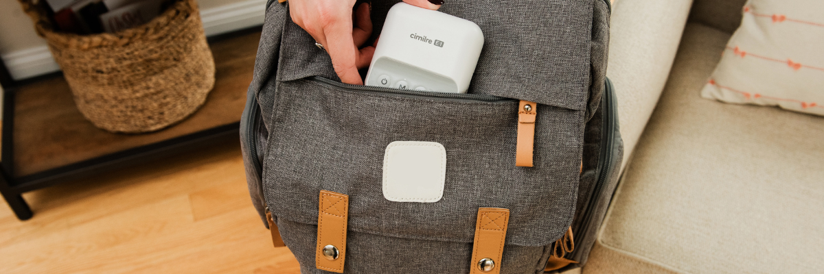 mom holding backpack, putting e1 into the front pocket